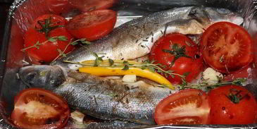 сибас, запеченный с томатами и травами